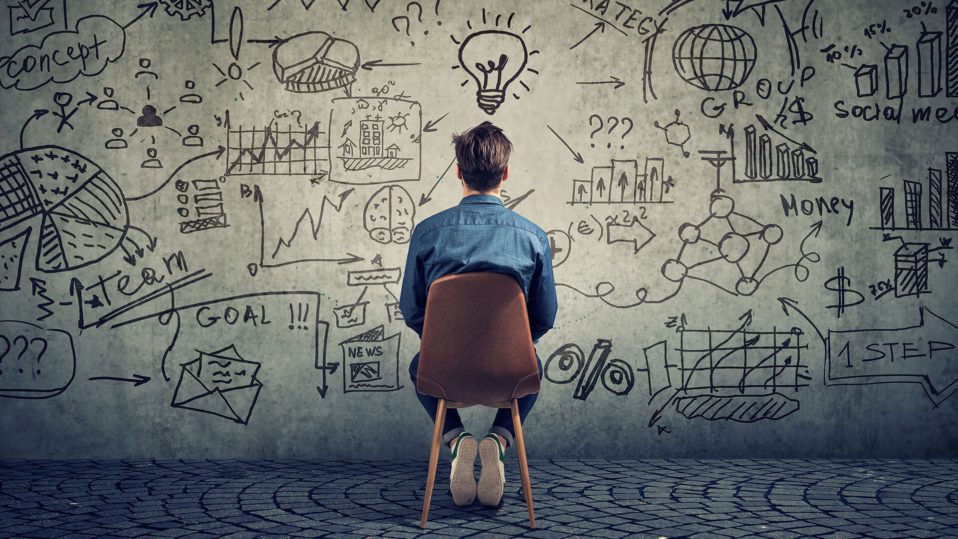 The royal commission in to aged care: A man sits with his back to the camera looking at a wall covered in illustrations that relate to a 'light bulb moment' that hovers above his head to help portray the message of what's coming next